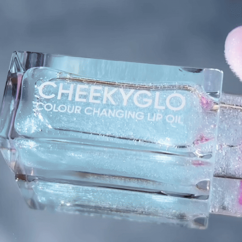 CheekyGlo Colour Changing Lip Oil in Candy shade being applied on the lips