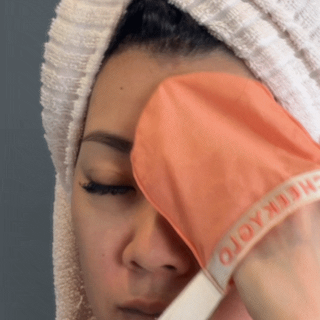 CheekyGlo Silk Exfoliating Face Mitt being used to remove dead skin and reveal smoother facial skin.