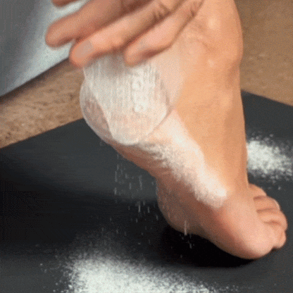 CheekyGlo Glass Foot File being scrubbed across the heel to buff away rough, dry, calloused skin and reveal smoother feet.