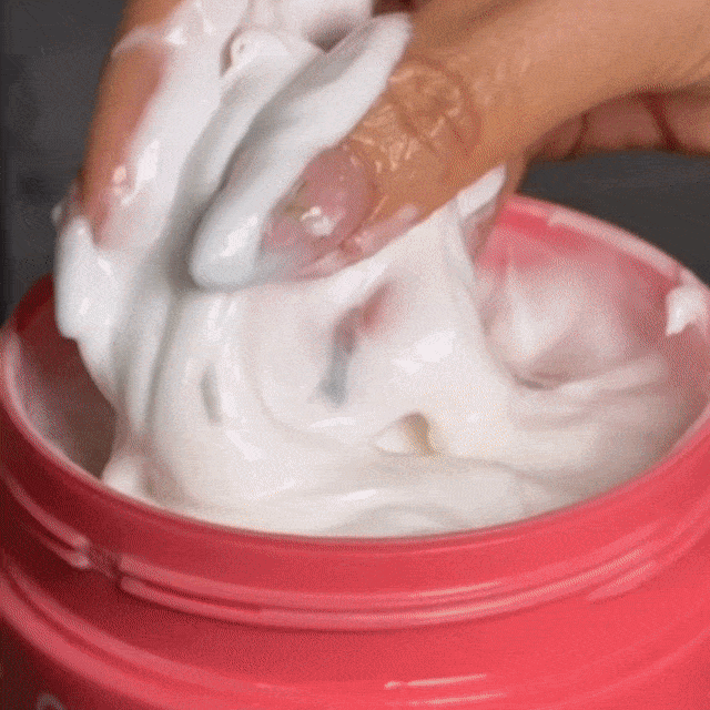 CheekyGlo Rapid Repair Hair Mask being applied and worked through the hair to smooth, soften, and repair damaged strands in 5 minutes.