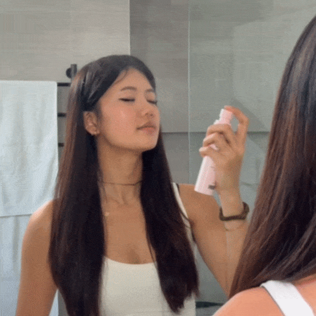 CheekyGlo Skin Reset Hypochlorous Acid Spray being spritzed across the face to calm redness, soothe breakouts, and refresh sensitive skin.