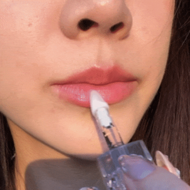 CheekyGlo Lip Repair Essence being applied to the lips, hydrating and repairing dry, chapped skin.