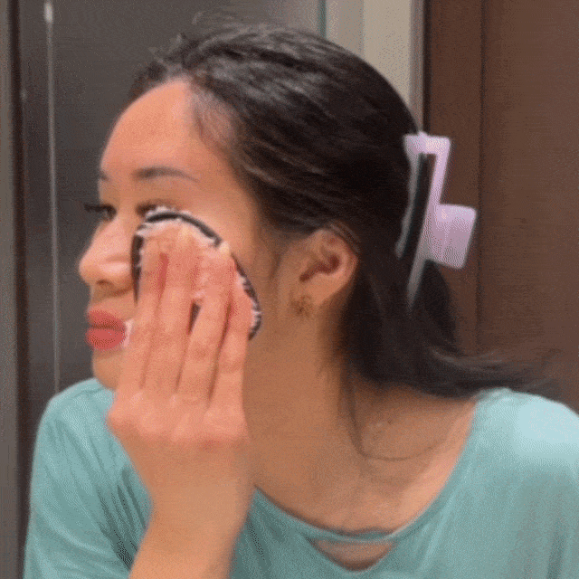 Woman using the CheekyGlo Makeup Eraser across the face, removing makeup and mascara with just water to leave skin clean and smooth
