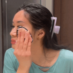 Woman using the CheekyGlo Makeup Eraser across the face, removing makeup and mascara with just water to leave skin clean and smooth