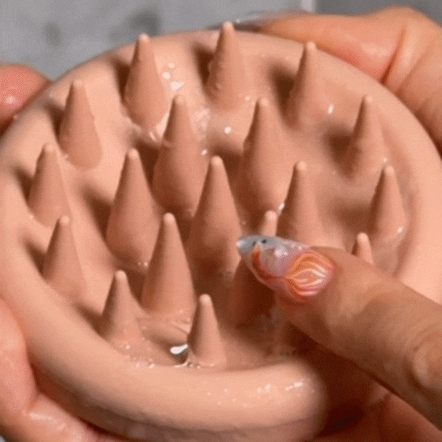 Woman using the CheekyGlo Scalp Scrubber through her hair, massaging and exfoliating the scalp to lift buildup and boost a healthy, clean feel.