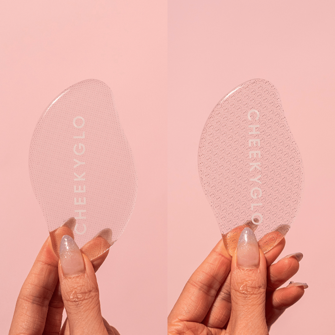 Two hands display CheekyGlo exfoliating pads against a pink backdrop. The left is smooth, the right angular, both showcasing &quot;CheekyGlo&quot; for removing dead skin and achieving silky feet akin to using a glass foot file.