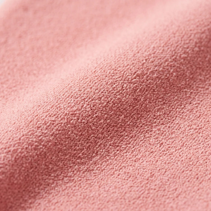 Pink exfoliating glove fabric close-up