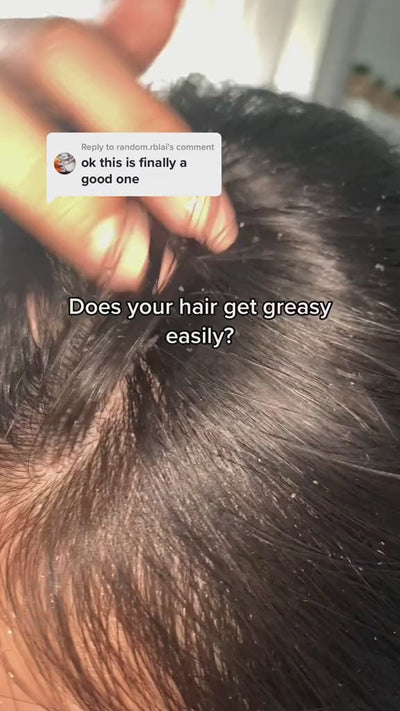 woman uses cheekyglo scalp scrubber to reduce greasy hair