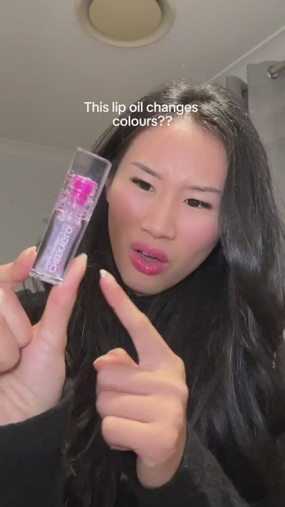 woman trying out cheekyglo colour changing lip oil with result