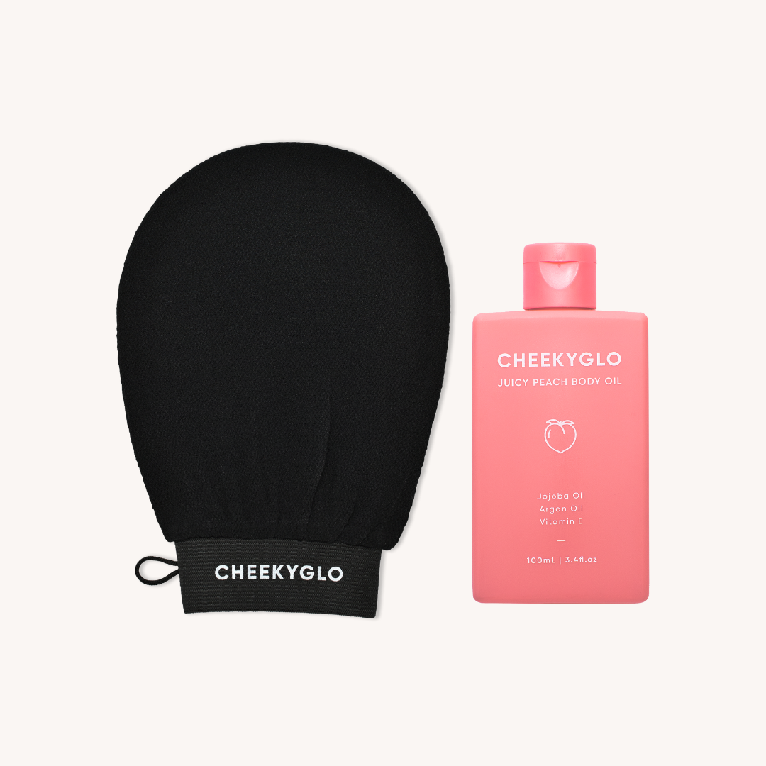 A black exfoliating glove labeled &quot;CheekyGlo&quot; alongside a 100ml (3.4 fl oz) bottle of &quot;CheekyGlo Juicy Peach Body Oil,&quot; perfect for sensitive skin and enriched with jojoba and argan oils plus vitamin E, are showcased on a light background. These items form the popular &quot;Glow Up Duo&quot; from CheekyGlo.