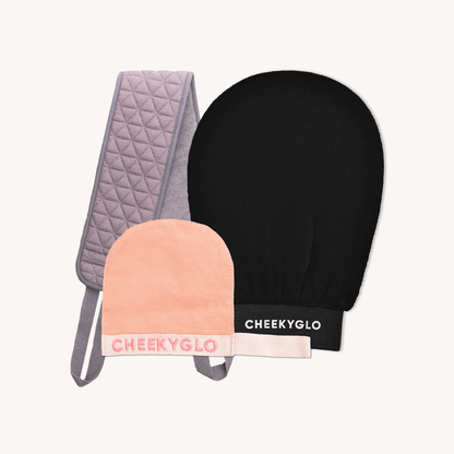 Introducing the Cheekybro Set by CheekyGlo—a skincare collection featuring a quilted grey exfoliating strap, a black exfoliating glove, and a peach-colored makeup-removing mitt with &quot;CHEEKYGLO&quot; branding—perfect for your self-care routine.