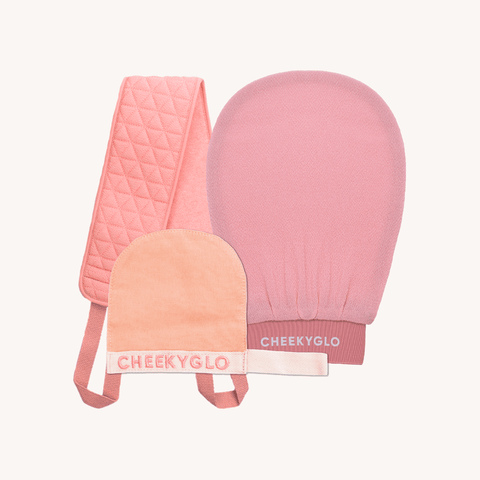 Introducing the Cheekybro Set from CheekyGlo, a collection of pink self-care skincare exfoliating accessories. This set features a textured body scrubber with handles, an exfoliating glove mitt, and a smaller textured face scrubber mitt. Each item is branded with 