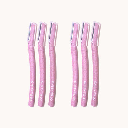 Six CheekyGlo Dermablades, each with a straight handle and a protective transparent cap covering the blade, are arranged in two rows of three. The handles are adorned with the brand name &quot;CheekyGlo&quot; printed in white, making them perfect for precise facial hair removal.