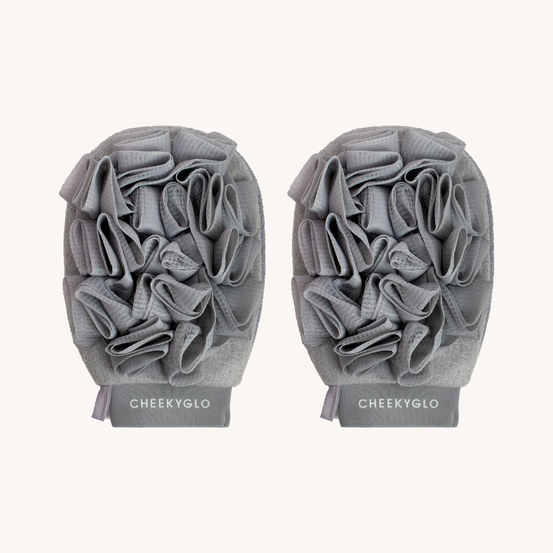 The CheekyGlo Exfoliating Loofah Glove is a pair of gray gloves designed for enhanced scrubbing and skin smoothing. Each glove features a ruffled texture and is made from a textured fabric, with the brand name &quot;CHEEKYGLO&quot; printed at the wrist section, making them perfect for addressing keratosis pilaris.