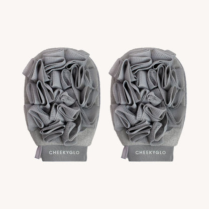 The CheekyGlo Exfoliating Loofah Glove is a pair of gray gloves designed for enhanced scrubbing and skin smoothing. Each glove features a ruffled texture and is made from a textured fabric, with the brand name &quot;CHEEKYGLO&quot; printed at the wrist section, making them perfect for addressing keratosis pilaris.