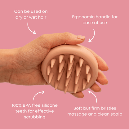 A hand holding the CheekyGlo Scalp Scrubber, a round, peach-colored tool with silicone teeth, against a pink background. Text around the massager highlights its features: suitable for wet or dry hair, ergonomic handle, 100% BPA-free silicone teeth for scrubbing, and soft yet firm bristles that promote healthy hair growth.