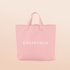 A light peach CheekyGlo Tote Bag with the brand name "CHEEKYGLO" printed in bold white capital letters across the center. This pink tote bag has sturdy reinforced handles at the top, making it ideal for carrying groceries while maintaining a soft and clean appearance.