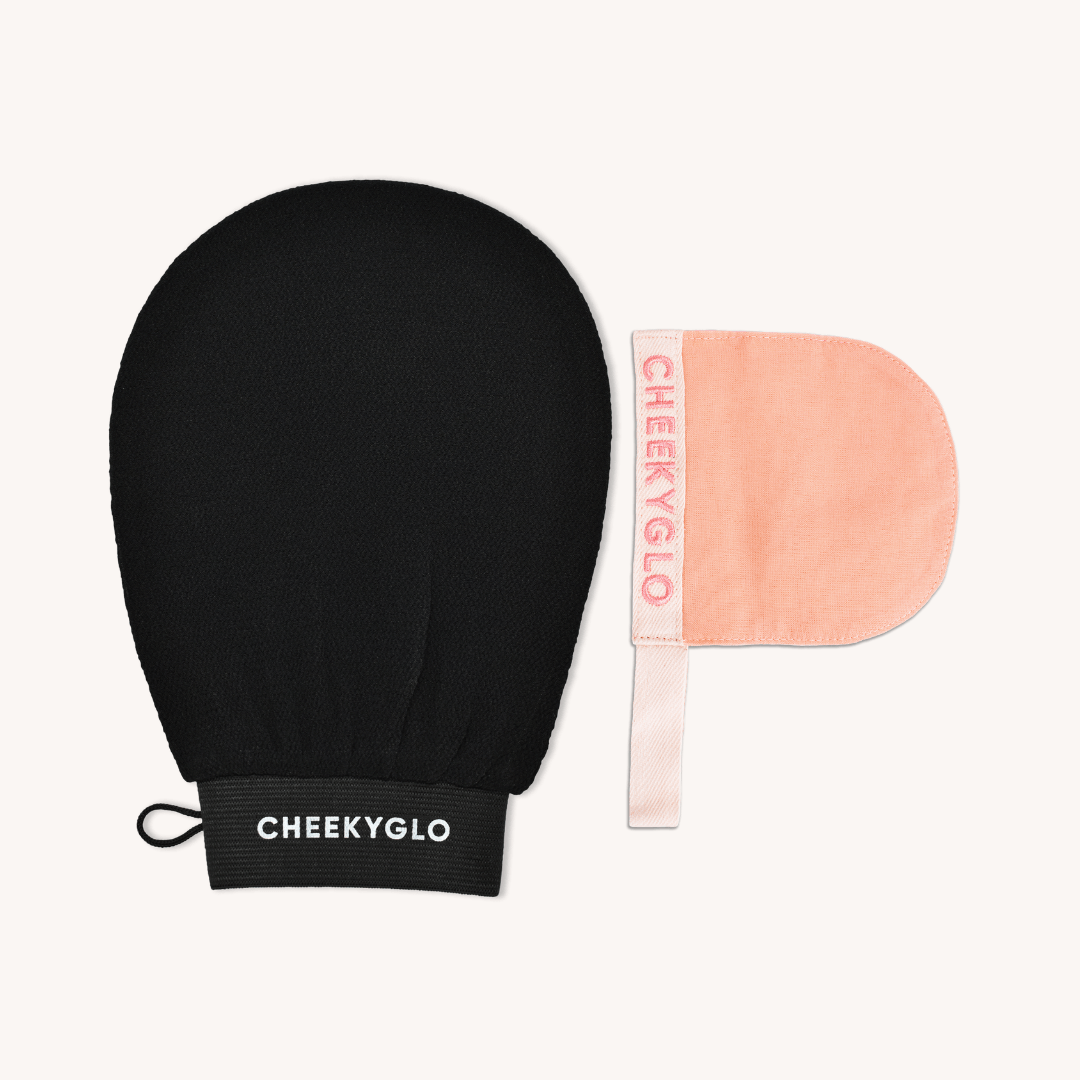 The image shows the Face+Body Exfoliating Duo of skincare exfoliating mitts. One exfoliating glove is black with a loop and the brand name &quot;CheekyGlo&quot; in white letters on the cuff, while the other is peach-colored with &quot;CheekyGlo&quot; in pink text along the side.